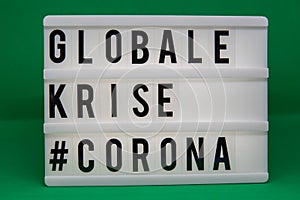 A light box with the inscription: GLOBALE  #CORONA with white background photo