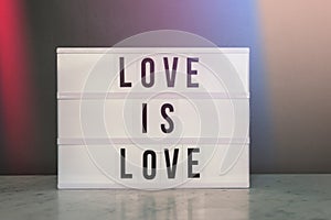 Light box with `love is love` and rainbow