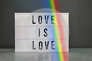 Light box with `love is love` and rainbow
