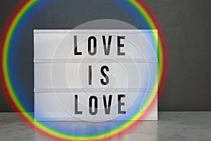 Light box with `love is love` and rainbow