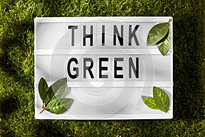 light box with think green words on grass