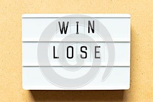 Light box with word win lose on wood background