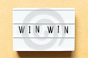 Light box with word win win on wood background