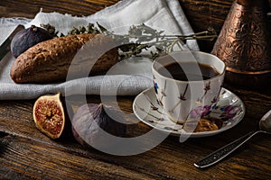 Light breakfast with coffee, bread and few figs.