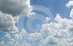 Light bright blue sky with fluffy white towering clouds - Replacement or background