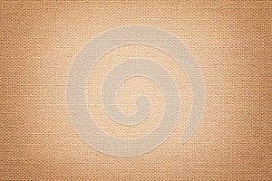 Light brown background from a textile material with wicker pattern, closeup photo