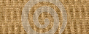 Light brown background from a textile material with wicker pattern, closeup. Vintage beige fabric with texture