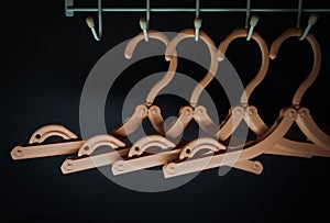 Light brown cloth hanger on dark background