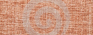 Light brown fluffy background of soft, fleecy cloth. Texture of orange textile backdrop