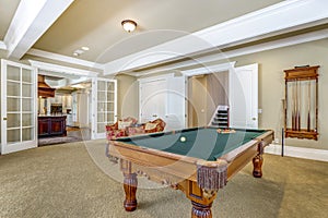 Light brown game room with billiard table