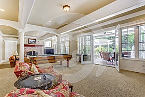 Light brown game room with billiard table