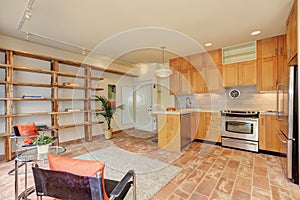 Light brown kitchen interior with sitting area.