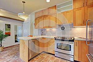Light brown kitchen interior with steel appliances
