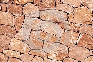 Light brown sandstone wall, stone wall background.