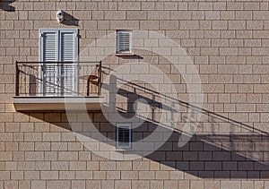 Light brown single modern balcony on paving stone wall