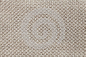 Light brown textile background with checkered pattern, closeup. Structure of the fabric macro.