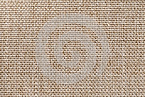Light brown textile background closeup. Structure of the fabric macro