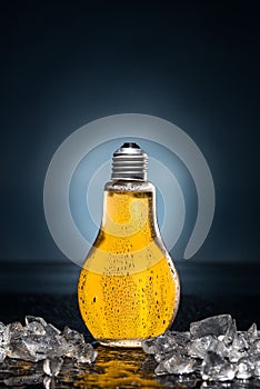 Light bulb beer with drops and ice