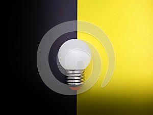 Light Bulb on Black and Yellow Paper