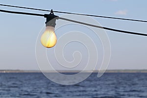 Light bulb on a blurred lake background