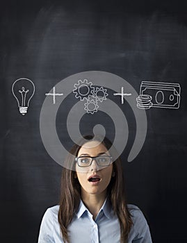 Light Bulb and Businesswoman on Blackboard