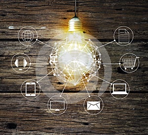 Light bulb circle global and icon customer network connection on wooden background