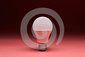 Light bulb, copy space. Energy saving minimal idea concept.Pink background