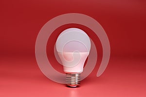 Light bulb, copy space. Energy saving minimal idea concept.Pink background