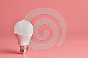 Light bulb, copy space. Energy saving minimal idea concept.Pink background