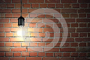 Light Bulb On Dark Brick Wall Background