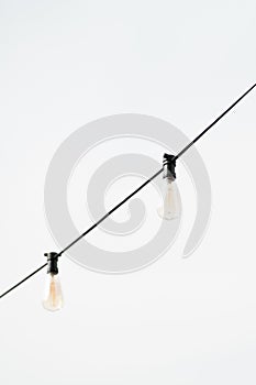 Light bulb decor hanging in outdoor against white background