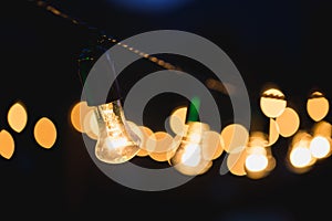 Light bulb decor in outdoor party. Evening wedding ceremony.