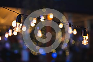 Light bulb decor in a street party at night.