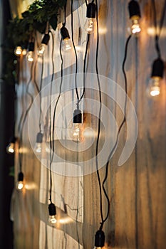 Light bulb decor at wall in outdoor party