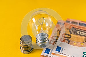 Light Bulb and european banknotes and coins