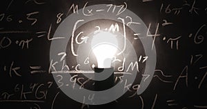 Light bulb flickering on in front of chalkboard full of equations. Concept of a fresh idea, innovation, inspiration, or