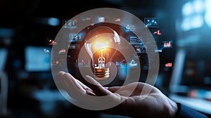 Light bulb glowing in hand, technology interface overlay, innovation concept