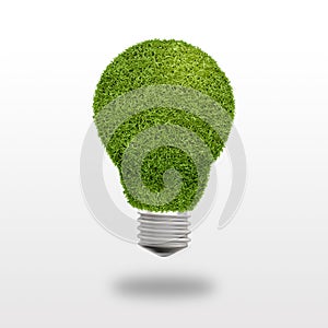 Light bulb with grass instead of glass on a white background