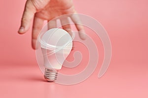 Light bulb and hand, idea catching concept. Symbol of new events or finding solutions to problems. Creative minimal innovations