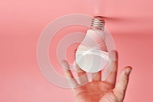 Light bulb and hand, idea catching concept. Symbol of new events or finding solutions to problems. Creative minimal innovations