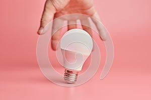 Light bulb and hand, idea catching concept. Symbol of new events or finding solutions to problems. Creative minimal innovations