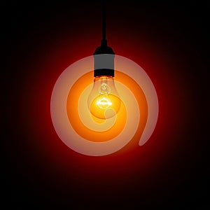 Light bulb hangs from a dark ceiling, emitting a warm, orange