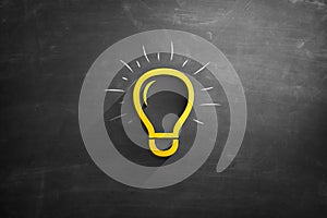 Light bulb icon on blackboard