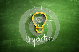 Light bulb icon and inspiration text on blackboard