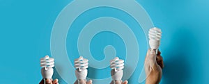 Light bulb idea energy hand holding light bulb on blue background Innovative idea Concept  innovation and inspiration