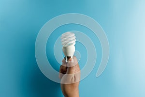 Light bulb idea energy hand holding light bulb on blue background Innovative idea Concept  innovation and inspiration