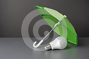 A light bulb idea under the insurance umbrella. Innovative solutions.