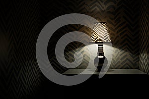 light bulb illuminating a dark room with shadows and patterns