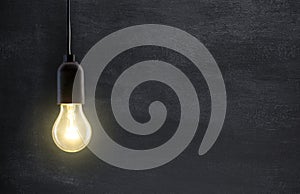 Light bulb lamp on blackboard photo