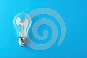 light bulb lit on blue background. winning idea concept.